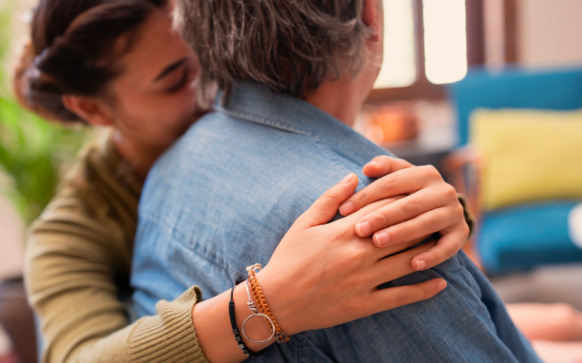 Close up woman holding grandparent close to her.