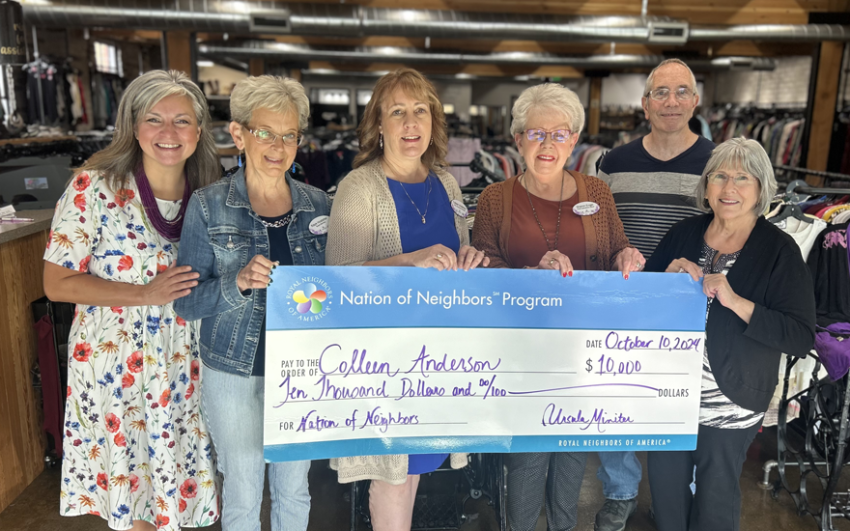 Group of happy people holding a giant $10,000 check.