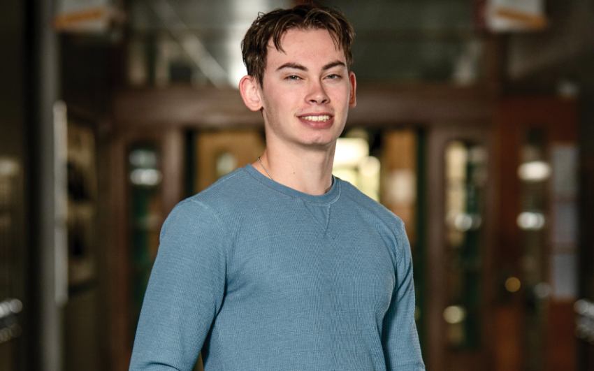 Happy young man in blue long-sleeved shirt.