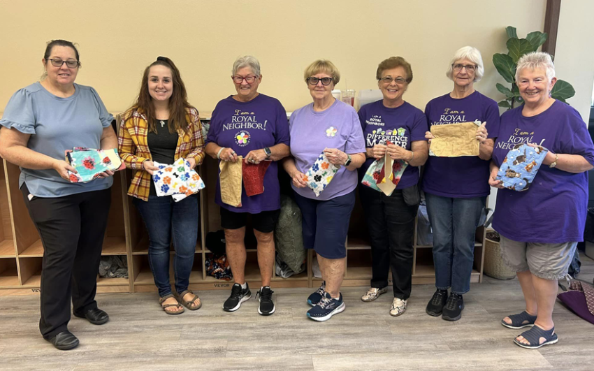 Group of happy women holding fabric marble mazes.