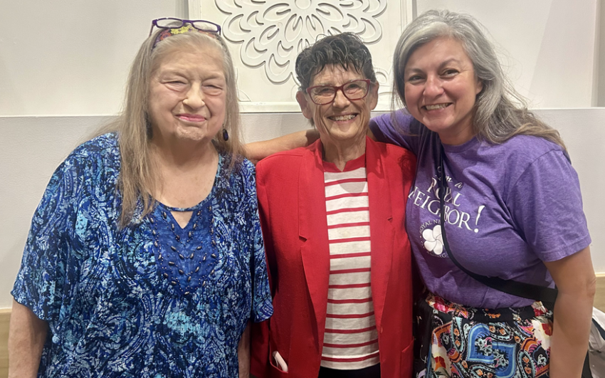 Three happy woman smiling, grouped together.